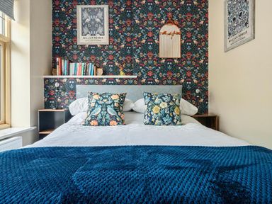 A bedroom with a bed and bookshelf at 20 Main Street in Heysham