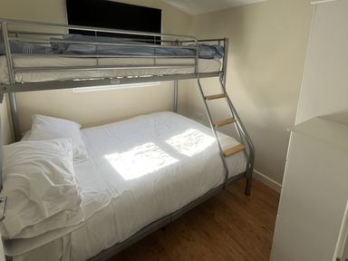 A bedroom with a bunk bed and a double bed at Embury