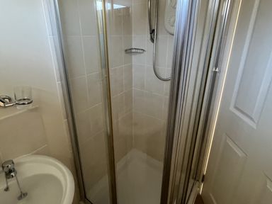 A shower enclosure with a sink in the bathroom at Embury