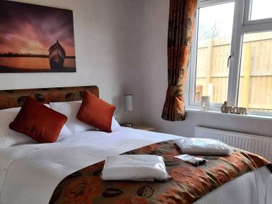 A bedroom with a bed and decorative items at 311 Bridlington