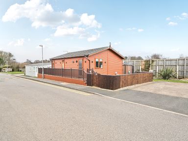 A house with a wooden fence and driveway at 311 Bridlington