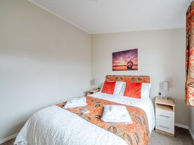 A bedroom with a bed and bedside tables at 311 in Bridlington