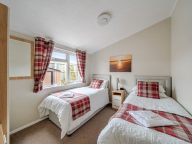 A bedroom with two beds and a nightstand at 311 in Bridlington