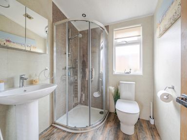 A bathroom with a shower, toilet, and sink at 311 in Bridlington