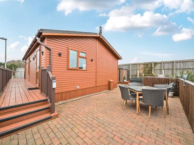 An outdoor area with a wooden house and dining set at 311 Bridlington