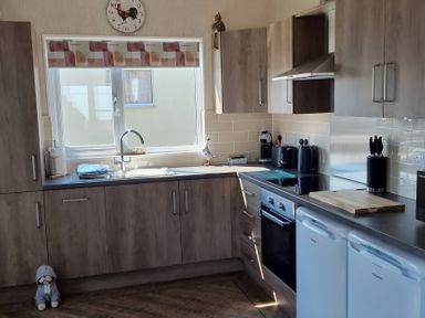 A kitchen with cabinets, sink, and appliances at 50 Bridlington