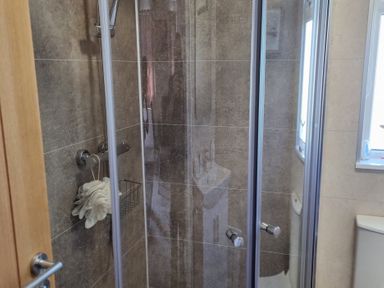 A shower cubicle with a towel in a bathroom at 50 in Bridlington