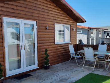An outdoor patio with a table and chairs at 50 Bridlington
