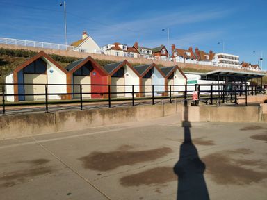 A row of beach huts by the shoreline at 50 Bridlington