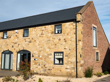 A stone and brick building with windows and a door at The Galloway in Morpeth