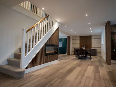 A dining room with a table and chairs and stairs at The Galloway in Morpeth