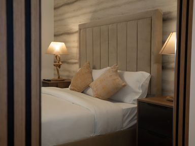 A bedroom with a bed and lamp at The Galloway in Morpeth