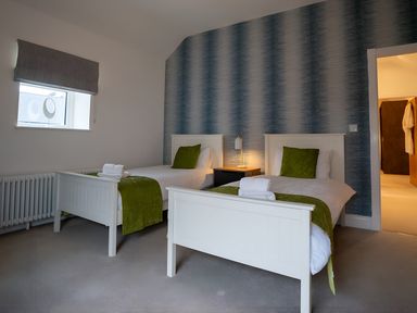 A bedroom with two beds and a nightstand at The Galloway in Morpeth