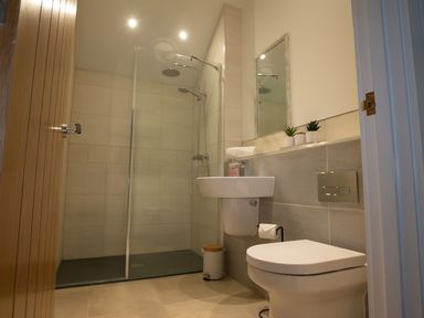 A bathroom with a shower, sink, and toilet at The Galloway in Morpeth