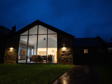 A house exterior with large windows and pathway at The Shearling in Morpeth