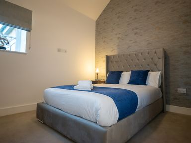 A bedroom with a bed and nightstand at The Shearling in Morpeth