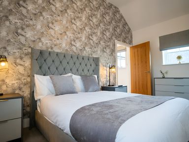 A bedroom with a bed and chest of drawers at The Shearling in Morpeth
