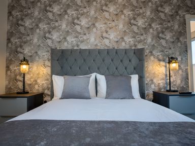 A bedroom with a bed and bedside tables at The Shearling in Morpeth