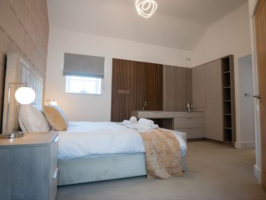 A bedroom with a bed and a nightstand at The Shearling in Morpeth