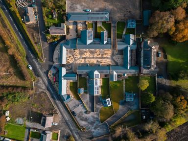 An aerial view of a complex with gardens and buildings at The Shearling in Morpeth