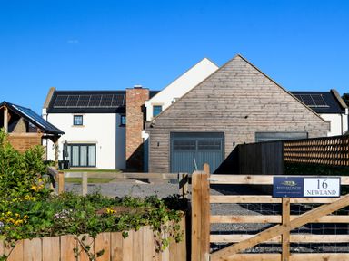 A house with a garage and solar panels at The Newland in Morpeth