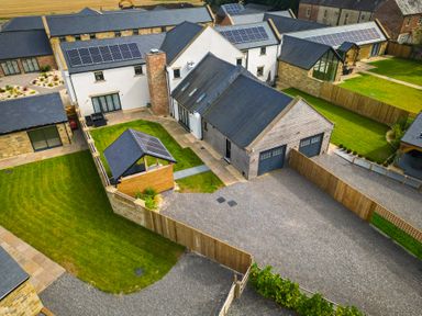 An outdoor view of buildings and a garden at The Newland in Morpeth