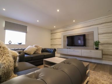 A living room with a sofa and television at The Newland in Morpeth