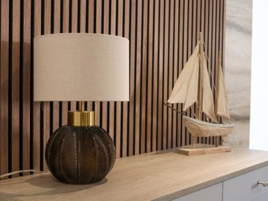 A lamp and a sailing boat on a wooden surface at The Newland in Morpeth
