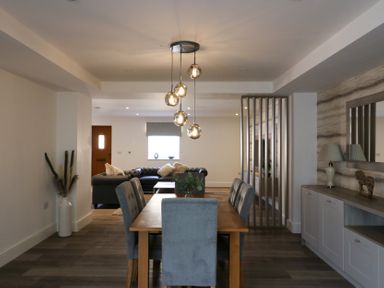 A dining room with a table and chairs overlooking a sofa at The Newland in Morpeth