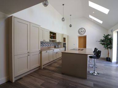 A kitchen with cabinets and an island at The Newland in Morpeth