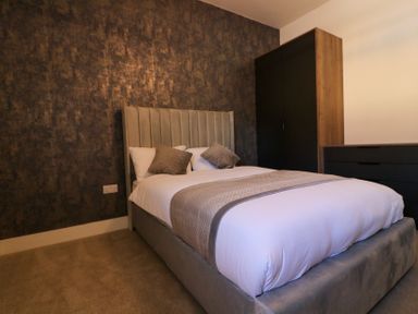 A bedroom with a bed and furniture at The Newland in Morpeth