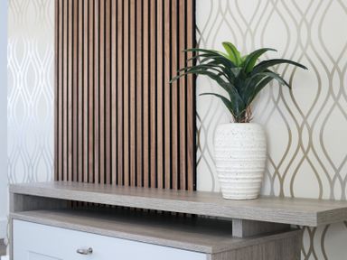 A living room with a plant in a vase on a shelf at The Newland in Morpeth