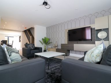 A living room with a sofa and television at The Gavel in Morpeth