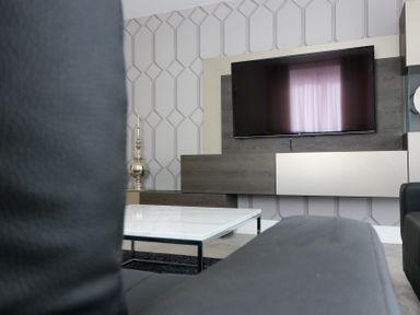 A living room with a television and coffee table at The Gavel in Morpeth