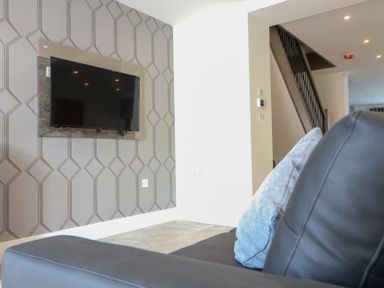 A living room with a television mounted on the wall at The Gavel in Morpeth