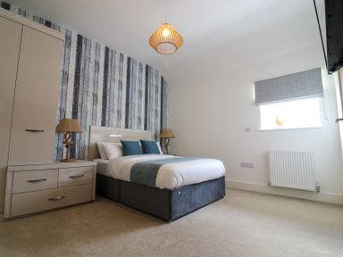 A bedroom with a bed and lamps next to it at The Gavel in Morpeth