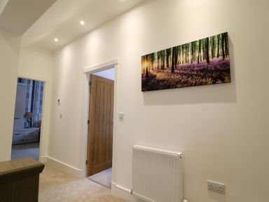 A hallway with a painting and a radiator at The Gavel in Morpeth