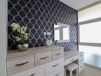 A bedroom with a dresser and mirror at The Gavel in Morpeth