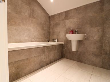 A bathroom with a bathtub and a sink at The Gavel in Morpeth