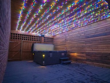 An outdoor area with a hot tub and string lights at The Gavel in Morpeth