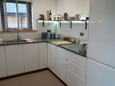 A kitchen with a sink, countertops, and appliances at Gowrie Lodge in Blairgowrie