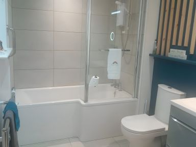 A bathroom with a bathtub and shower at Gowrie Lodge Blairgowrie