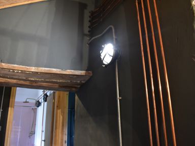 A room with copper pipes and a light fixture at Ty Llaeth in Carmarthen