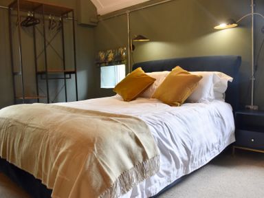 A bedroom with a bed and pillows at Ty Llaeth in Carmarthen