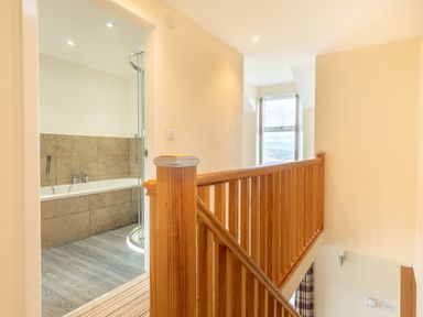 A bathroom with a bathtub and shower at Groeslon Uchaf Caernarfon
