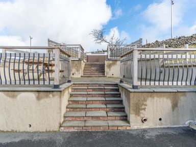 Stairs leading to a terrace with railings at Groeslon Uchaf in Caernarfon