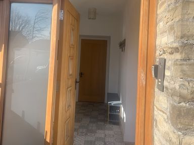 An entrance hall with a coat rack and console table at 4 Bickington Road Barnstaple