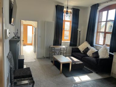 A living room with a sofa and coffee table at 4 Bickington Road in Barnstaple