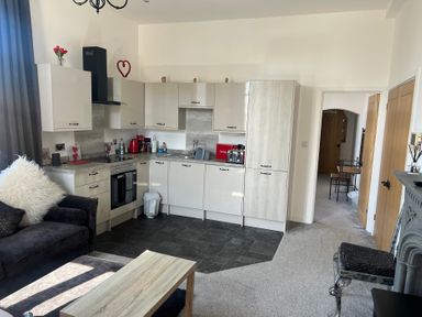 A kitchen with a sofa and table at 4 Bickington Road in Barnstaple