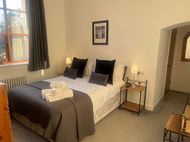 A bedroom with a bed and bedside table at 4 Bickington Road in Barnstaple